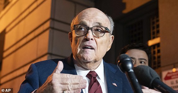 FILE - Former New York Mayor Rudy Giuliani talks to reporters as he leaves the federal courthouse in Washington, Dec. 11, 2023. A judge threw out Rudy Giuliani's bankruptcy case on Friday, July 12, 2024, finding that the former New York City mayor had flouted the process with a lack of transparency. (AP Photo/Jose Luis Magana, File)