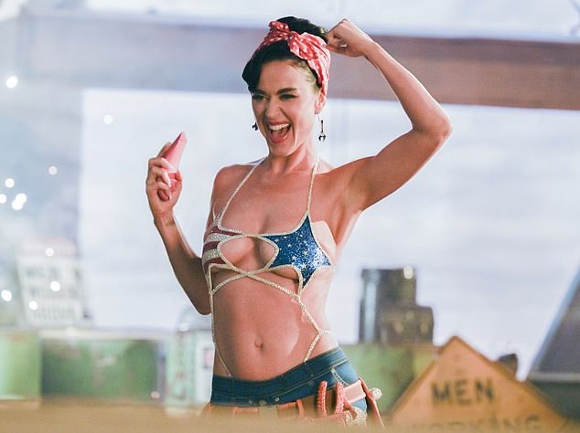 The Women's World video, released on Thursday, sees Katy Perry channeling a sexy Rosie the Riveter as she sings about female empowerment and holds a vibrator