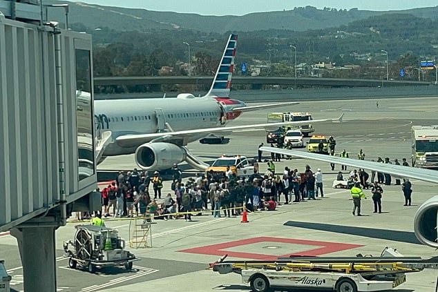 An American Airlines Airbus plane is pictured being evacuated at San Francisco International Airport Friday after a fire broke out on board