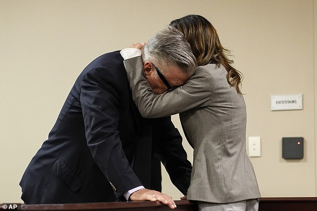 Alec Baldwin broke down in tears and hugged his wife Hilaria as his involuntary manslaughter case was sensationally dismissed