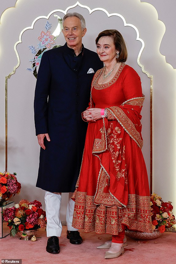 Former British Prime Minister Tony Blair and his wife Cherie Blair pose for pictures on the red carpet on the day of the wedding of Anant Ambani and Radhika Merchant in Mumbai, India, July 12, 2024. REUTERS/Francis Mascarenhas