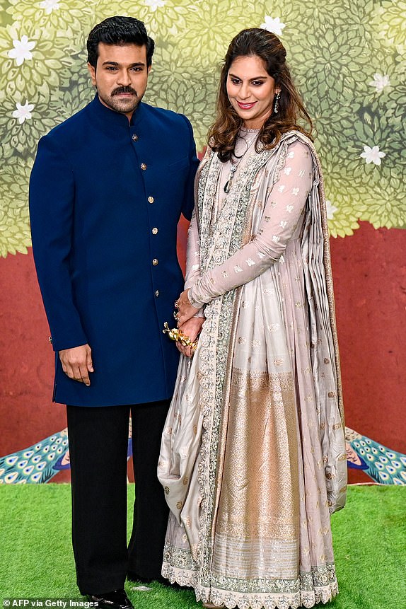 Indian actor Ram Charan (L) with his wife poses as they arrive at the blessing ceremony of billionaire Mukesh Ambani's son Anant Ambani and Radhika Merchant, after their wedding in Mumbai on July 13, 2024. Lavish wedding celebrations for the son of Asia's richest man resumed July 13 with a star-studded guest list including Hollywood celebrities, global business leaders and two former British prime ministers. (Photo by Punit PARANJPE / AFP) (Photo by PUNIT PARANJPE/AFP via Getty Images)