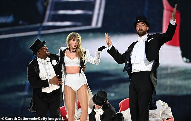 Swift is joined on stage by Travis Kelce (R), during "Taylor Swift | The Eras Tour" at Wembley