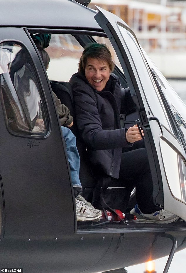 Tom was all smiles as he opened the helicopter door after landing