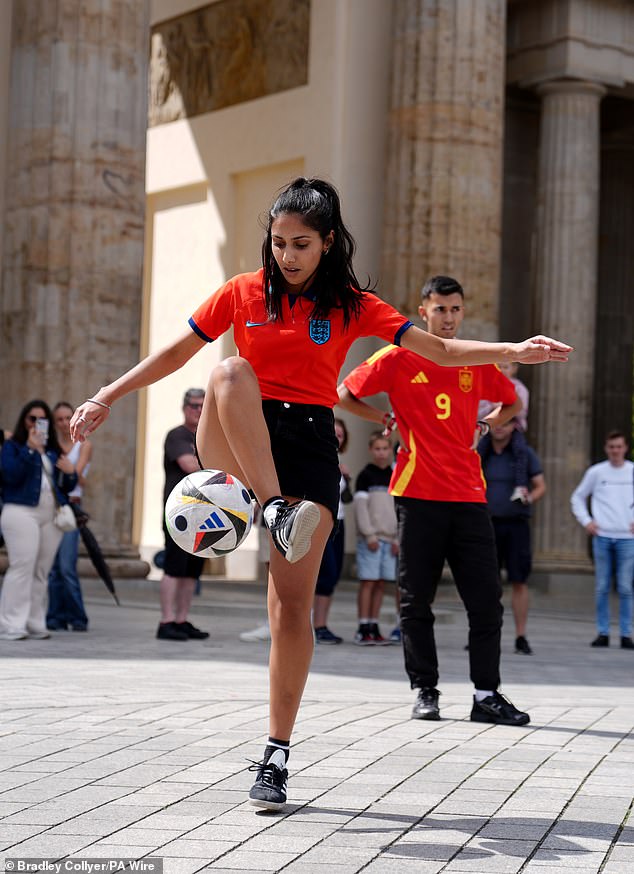 An England fans shows off her skills to fellow supporters in Berlin on Saturday afternoon