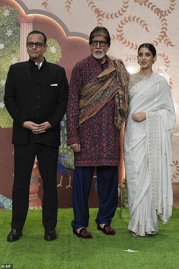 Indian actor Amitabh Bachchan, center, Navya Nanda, right and Nikhil Nanda pose for a picture during the blessing ceremony of newly wed couple Anant Ambani son of billionaire Mukesh Ambani's and his wife Radhika Merchant at Jio World Convention Centre in Mumbai, India, Saturday, July 13, 2024.(AP Photo /Rajanish Kakade)