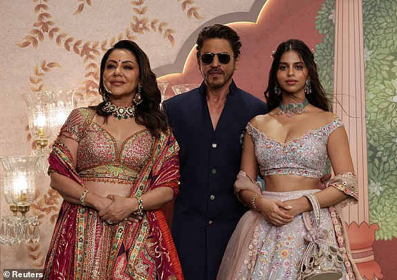 Bollywood actor Shah Rukh Khan, his wife Gauri Khan and their daughter Suhana Khan pose for pictures on the red carpet as they attend the blessing ceremony of Anant Ambani and Radhika Merchant after their marriage in Mumbai, India, July 13, 2024. REUTERS/Francis Mascarenhas