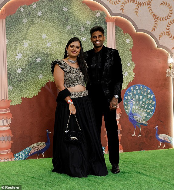 Indian cricketer Surya Kumar Yadav and his wife Devisha Shetty pose for pictures on the red carpet as they attend the blessing ceremony of Anant Ambani and Radhika Merchant after their marriage in Mumbai, India, July 13, 2024. REUTERS/Francis Mascarenhas