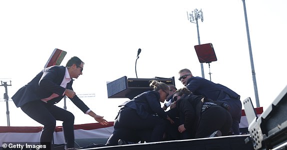 BUTLER, PENNSYLVANIA - JULY 13: Republican presidential candidate former President Donald Trump is rushed offstage during a rally on July 13, 2024 in Butler, Pennsylvania. (Photo by Anna Moneymaker/Getty Images)