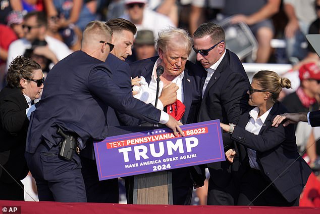 Initially dazed, Trump said, 'let me get my shoes on,' before the security detail conducted him off the stage