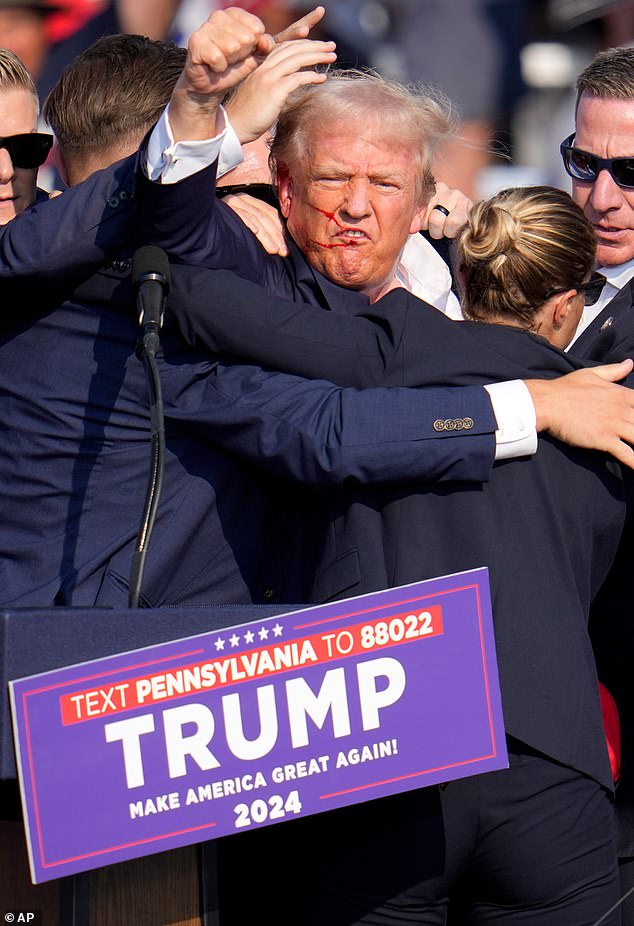 Before leaving the stage, Trump defiantly shook his fist before the crowd