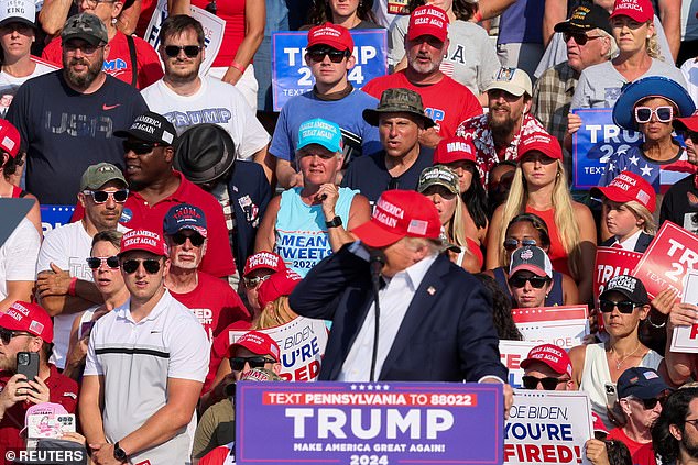 Trump grabbed at the side of his head as he appeared to be hit