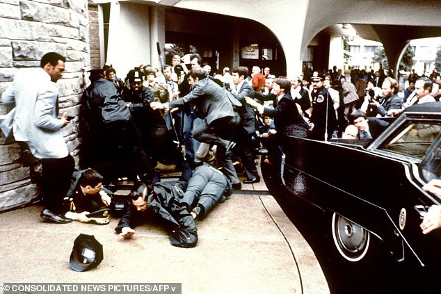 This photo taken by presidential photographer Mike Evens on March 30, 1981 shows police and Secret Service agents reacting during the assassination attempt on then US president Ronald Reagan