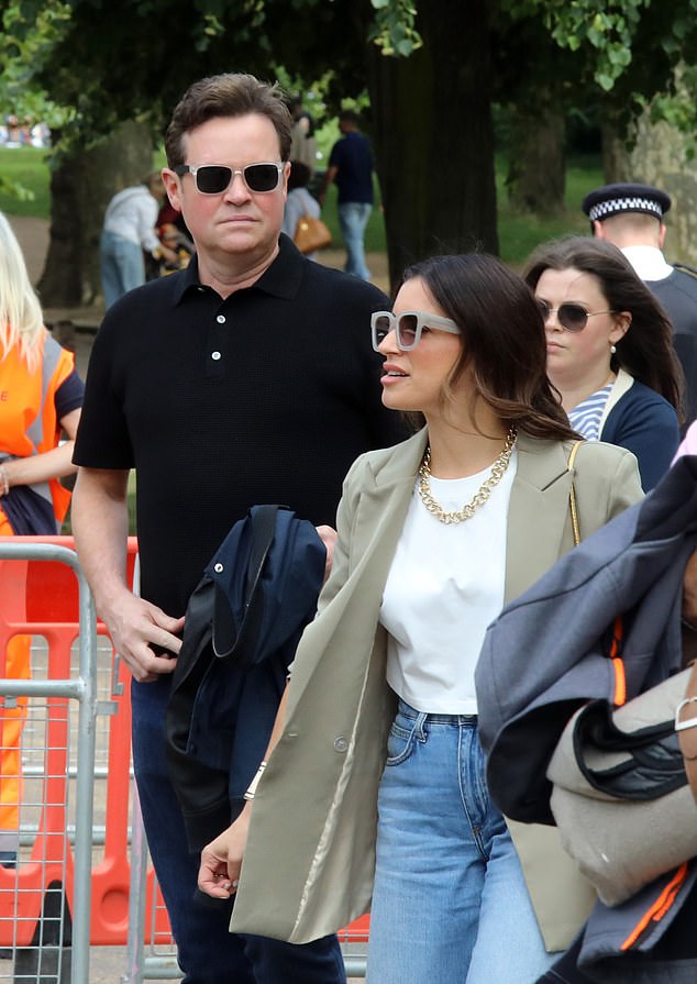 The In For A Penny host cut a smart figure in a black T-shirt which he teamed with navy trousers, white trainers and a pair of sunglasses