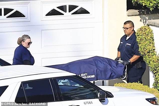 Pictures show the coroner taking Simmons' body out of his home on a stretcher