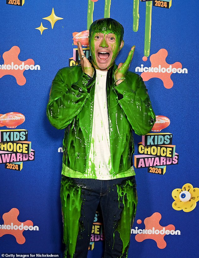 Henry Golding, who presented at the annual award ceremony, was seen posing after getting properly slimed