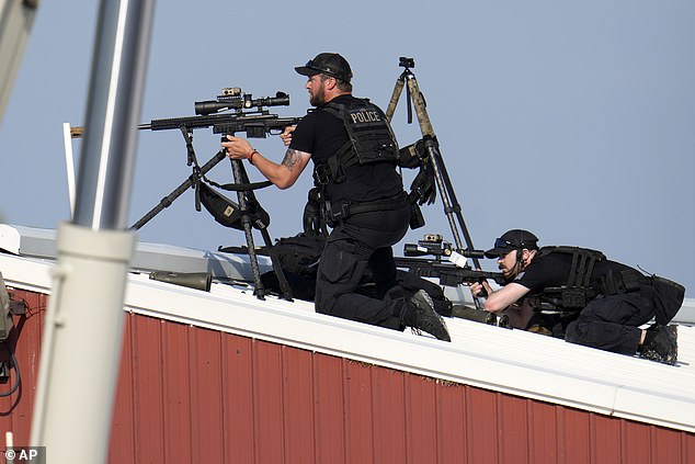 The footage shows the agents on top of a building above the rally stage in Butler, Pennsylvania, as shots rang out. Photos show agents on the roof