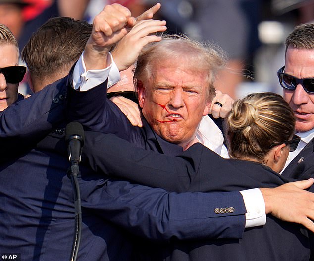 Trump remained defiant after the attack, energetically pumping his fist before the crowd