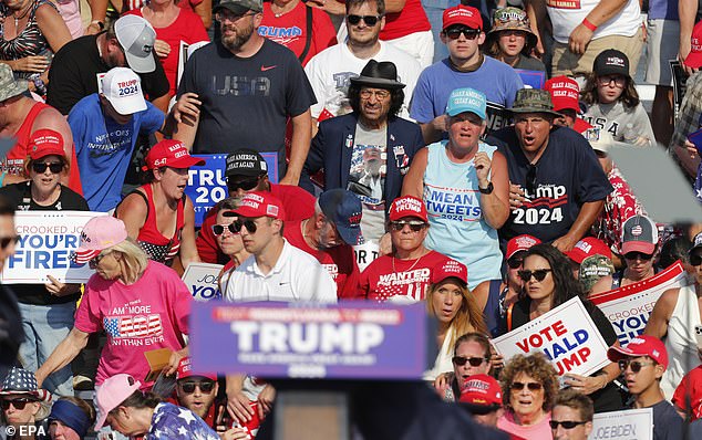 Former President Donald Trump goes down after the gunfire at his rally. Supporters in the back look about