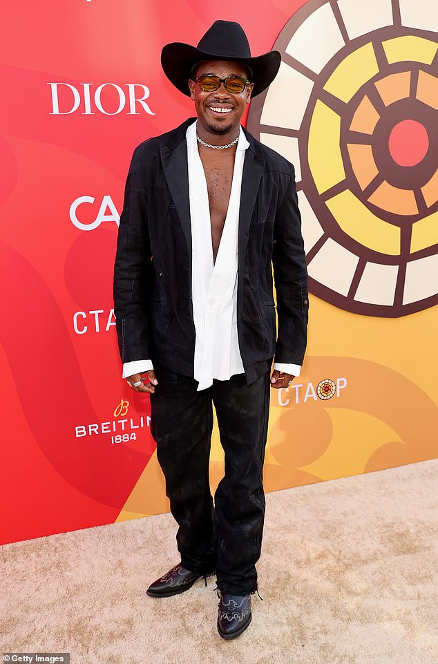 Dexter Darden made a statement wearing a pair of black pants as well as matching jacket and a white shirt that was partially unfastened at the front