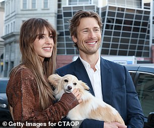 Daisy and Glen held cheerful smiles as the cute dog joined in on the fun at the event held at Universal Studios Backlot