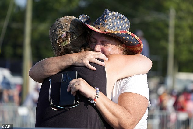 Witnesses hug after seeing the assassination attempt