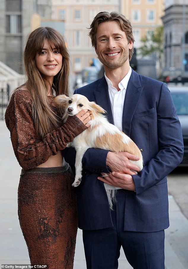 The two entertainers flashed their megawatt smiles as they cuddled an adorable brown and white dog