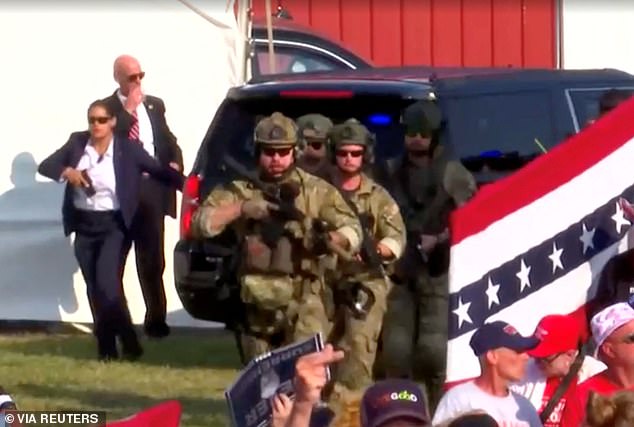 A huge law enforcement presence took over the area, including a number of camouflaged law enforcement officers emerging from the side of the stage