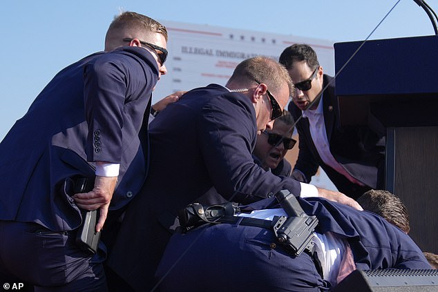 Agents formed a human shield on top of the former president as pandemonium took over the event