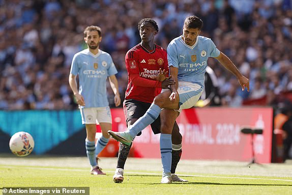 Soccer Football - FA Cup - Final - Manchester City v Manchester United - Wembley Stadium, London, Britain - May 25, 2024  Manchester City's Rodri in action with Manchester United's Kobbie Mainoo Action Images via Reuters/Andrew Couldridge