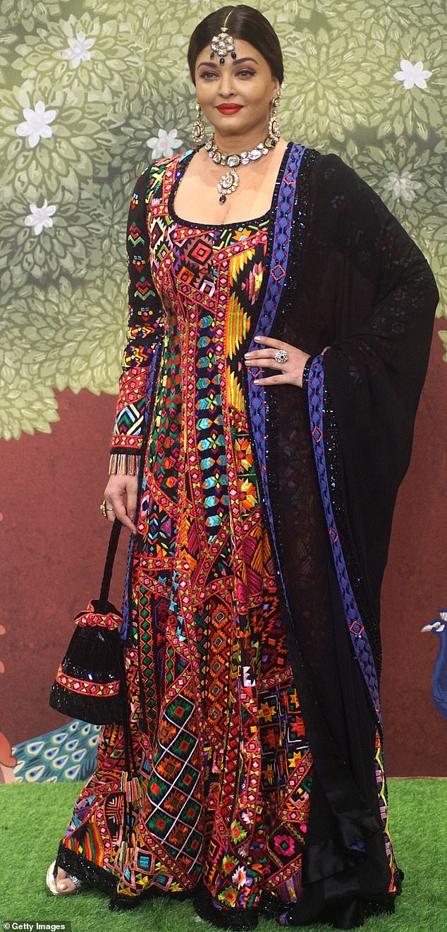 Aishwarya Rai Bachchan was camera ready in a black and orange patterned sari at the lavish celebration