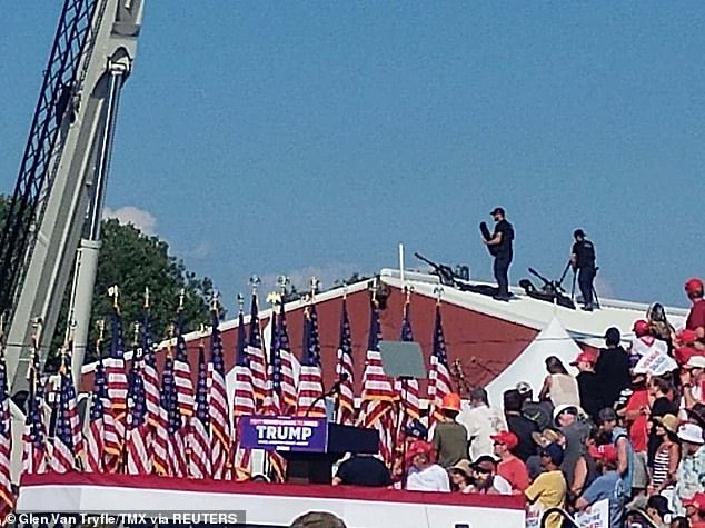 Snipers stand on a roof at Republican presidential candidate and former US President Donald Trump's campaign rally in Butler