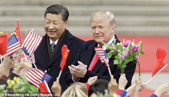 FILE: Bloomberg Best Of U.S. President Donald Trump 2017 - 2020: U.S. President Donald Trump, right, and Xi Jinping, China's president, greet attendees waving American and Chinese national flags during a welcome ceremony outside the Great Hall of the People in Beijing, China, on Thursday, Nov. 9, 2017. Our editors select the best archive images looking back at Trumps 4 year term from 2017 - 2020. Photographer: Qilai Shen/Bloomberg via Getty Images