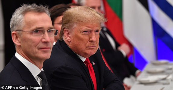 NATO Secretary General Jens Stoltenberg (L) looks on as US President Donald Trump gestures during a working lunch at the NATO summit at the Grove hotel in Watford, northeast of London on December 4, 2019. (Photo by Nicholas Kamm / AFP) (Photo by NICHOLAS KAMM/AFP via Getty Images)