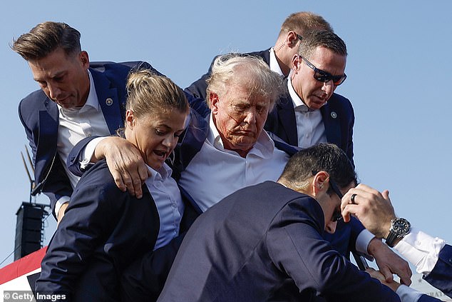 Trump was seen surrounded by Secret Service agents following the incident as he was rushed to hospital with blood pouring down his face