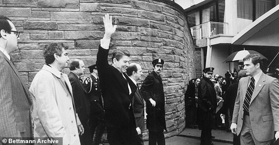 (Original Caption) Washington: The White House released this photograph made at the Capitol Hilton seconds before President Reagan was shot. The picture shows all four people who were shot in the assassination attempt. They are Press Secretary James Brady (third from left), President Reagan, D.C. Policeman Thomas K. Delahanty (in front of press corps at right, looking toward Reagan) and Secret Service agent Timothy J. McCarthy (R). The gunman is concealed behind officer Delahanty.