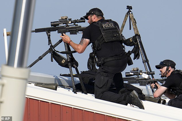 Police snipers return fire after shots were fired while Trump was speaking at a campaign rally