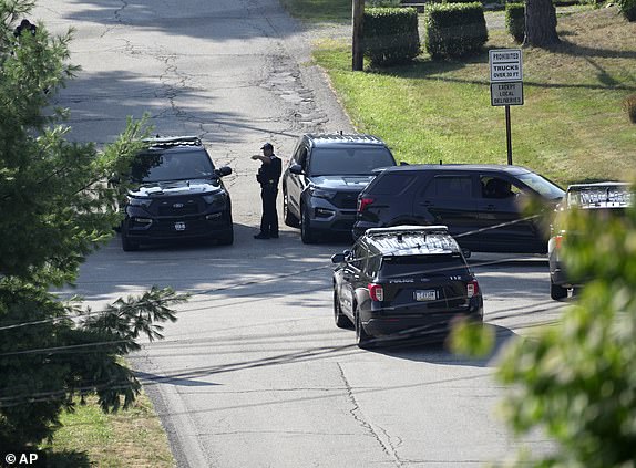 Law enforcement block a street in Bethel Park, Pa., that they say was a residence of Thomas Matthew Crooks, the suspected shooter of former President Donald Trump, Sunday, July 14, 2024. (AP Photo/Joshua A. Bickel)