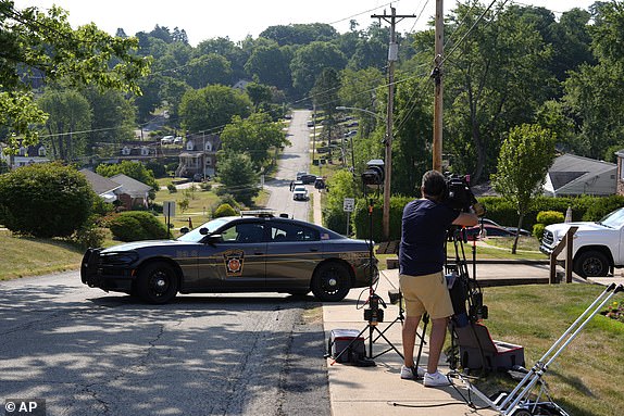 Law enforcement block a street in Bethel Park, Pa., that they say was a residence of Thomas Matthew Crooks, the suspected shooter of former President Donald Trump, Sunday, July 14, 2024. (AP Photo/Joshua A. Bickel)