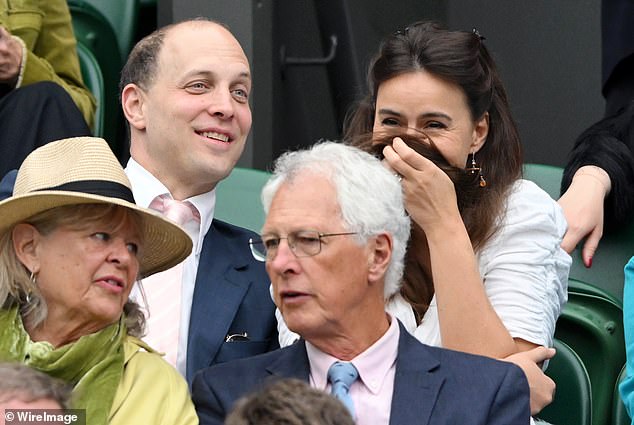 As they sat down for the tennis match, Sophie appeared to be hiding her face in her hair as they shared a giggle while watching