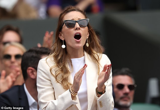 Jelena Djokovic stands on her feet in the Player's Box to cheer on her husband in an emotional show of support