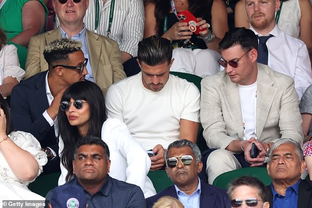 The football's not on yet Jack! Manchester City's £100m star Jack Grealish checks his phone during the Wimbledon men's final