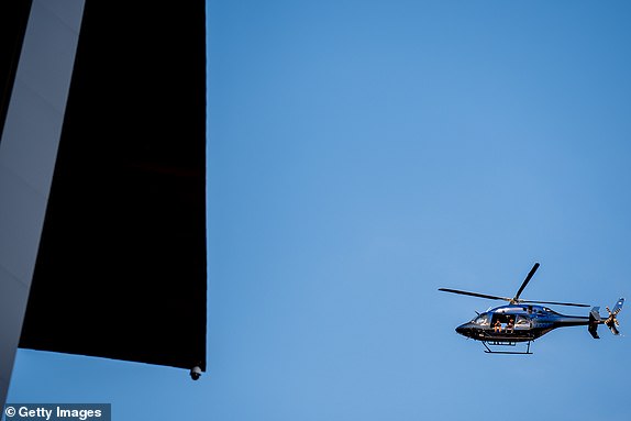 MILWAUKEE, WISCONSIN - JULY 13: A helicopter flies overhead outside the Fiserv Forum, which is scheduled to host the Republican National Convention (RNC), shortly after presumptive Republican presidential nominee former President Donald Trump was injured at a rally in Pennsylvania on July 13, 2024 in Milwaukee, Wisconsin. According to Butler County District Attorney Richard Goldinger, the suspected gunman is dead after grazing former President Trump with a bullet, killing one audience member and injuring at least one other. (Photo by Andrew Harnik/Getty Images)