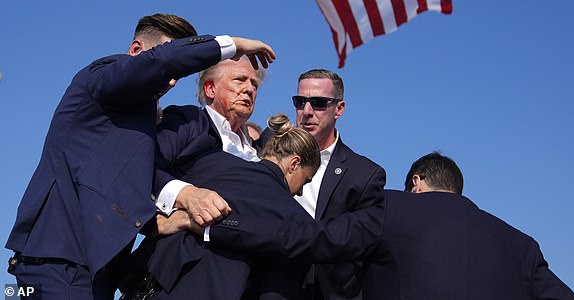 Republican presidential candidate former President Donald Trump is surround by U.S. Secret Service agents at a campaign rally, Saturday, July 13, 2024, in Butler, Pa. (AP Photo/Evan Vucci)