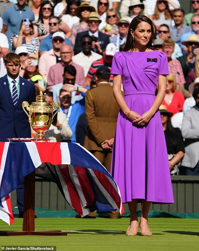 Kate awaits to sit give the trophy to the winner