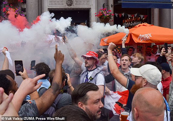 Mandatory Credit: Photo by Vuk Valcic/ZUMA Press Wire/Shutterstock (14586139f) England fans set off smoke flares outside the Admiralty pub in Trafalgar Square in London ahead of the Euro 2024 soccer final with Spain in Berlin. England fans gather in London ahead of the Euro 2024 final with Spain, Uk - 14 Jul 2024