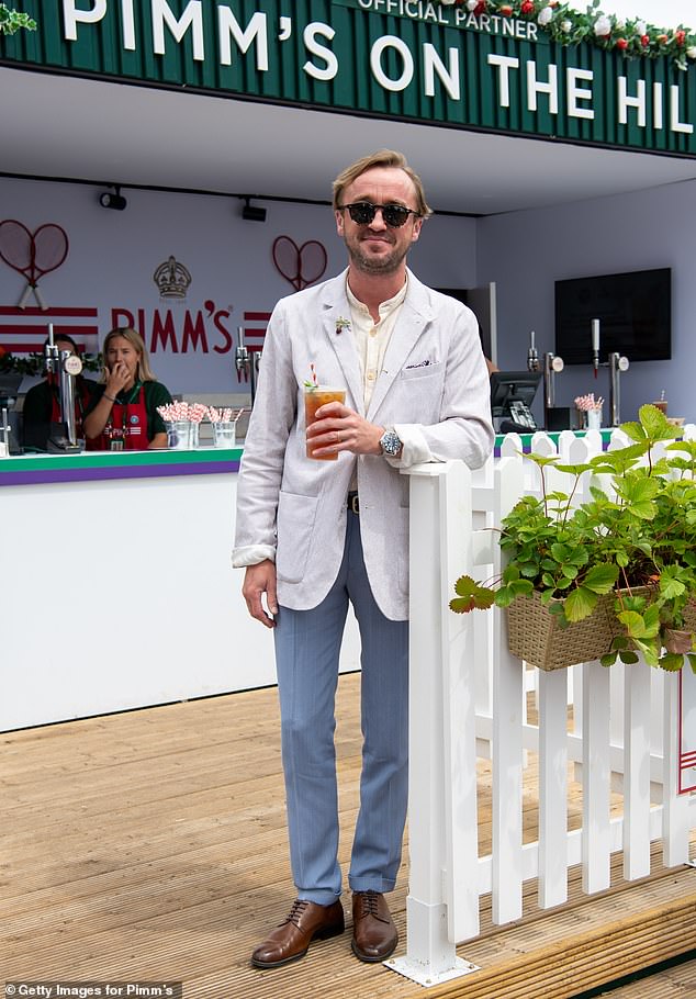 Tom Felton cut a smart figure as he enjoyed a Pimm's before watching the final