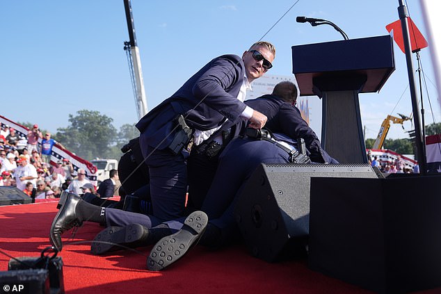 Secret Service agents raced to the stage and bundled Trump to the floor after shots were fired