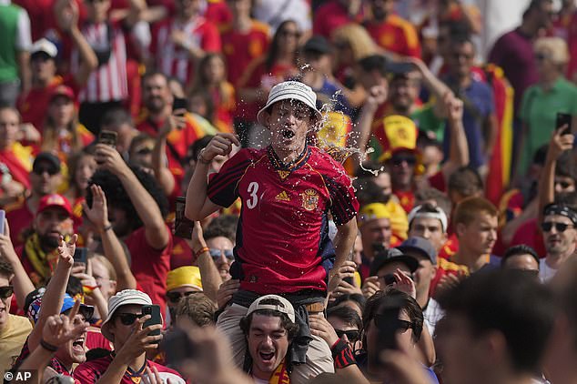 Fans of Spain cheer in Berlin fair before the start of the final