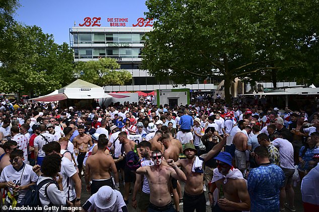 British football fans gather and chant slogans as they wait for the UEFA EURO 2024 final match